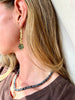 Drop earrings of stacked green pearls with complimentary abalone disks.   Materials Matter: green rice pearls with blue green farmed abalone disks on gold fill ear wires.   Made by Badass Women for Badass People: Designed in California by Carrie Marill and made by hand in her SoCal studio.