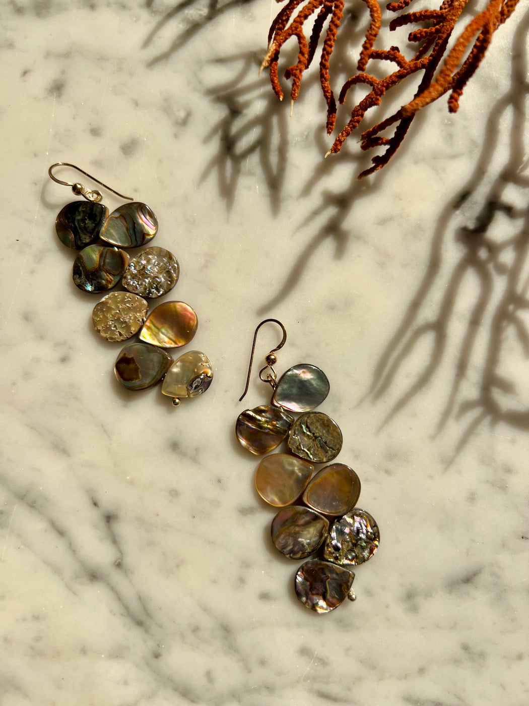 Stacked abalone earrings which flutter with movement as you wear them.  Materials Matter: farm raised abalone beads on gold fill ear wires.  Made by Badass Women for Badass People: Designed in California by Carrie Marill and made by hand in her SoCal studio.