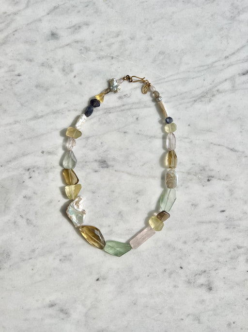 Earth Goddess energy radiates from this multi stone necklace ~ an array of stones to supercharge your aura.    Fluorite, topaz, citrine, smokey quartz, freshwater Pearl, iolite, rose quartz, lavender quartz strung on gold coated wire with gold fill findings.