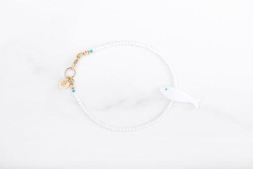 A Zen moment around your wrist. A pretty little 7” bracelet with natural white bamboo coral and shell fish with gold fill details and clasp. 