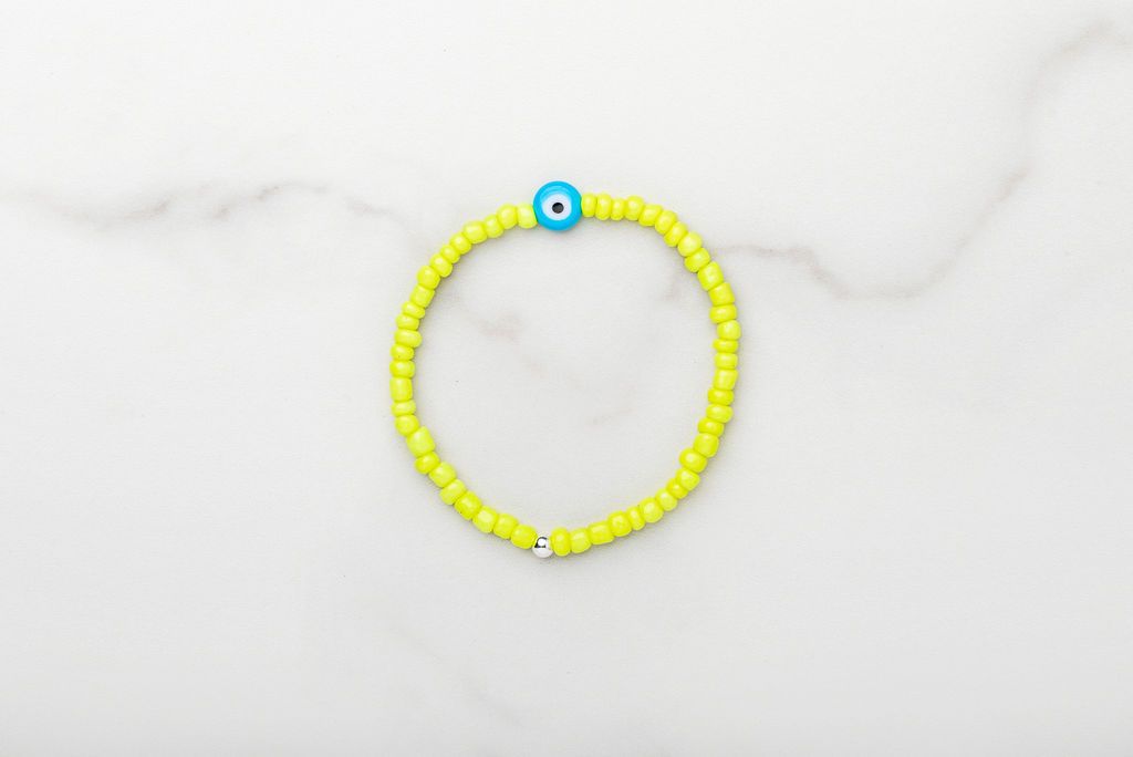Neon yellow Japanese glass beads on sturdy elastic. For that little pop of color and protection for your personal space bubble. Wear just one or stack 'em.