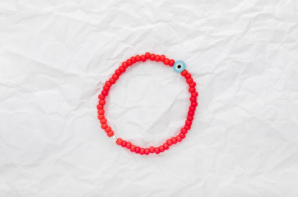 Bright red Japanese glass beads on sturdy elastic. For that little pop of color and protection for your personal space bubble. Wear just one or stack 'em.
