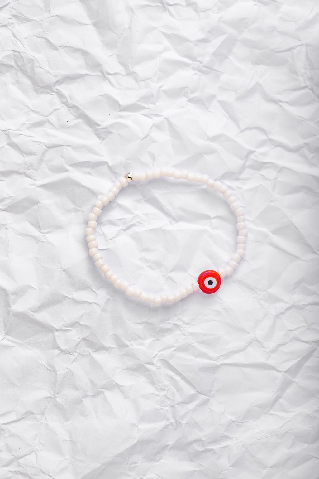 White Japanese glass beads on sturdy elastic. For that little pop of color and protection for your personal space bubble. Wear just one or stack 'em.