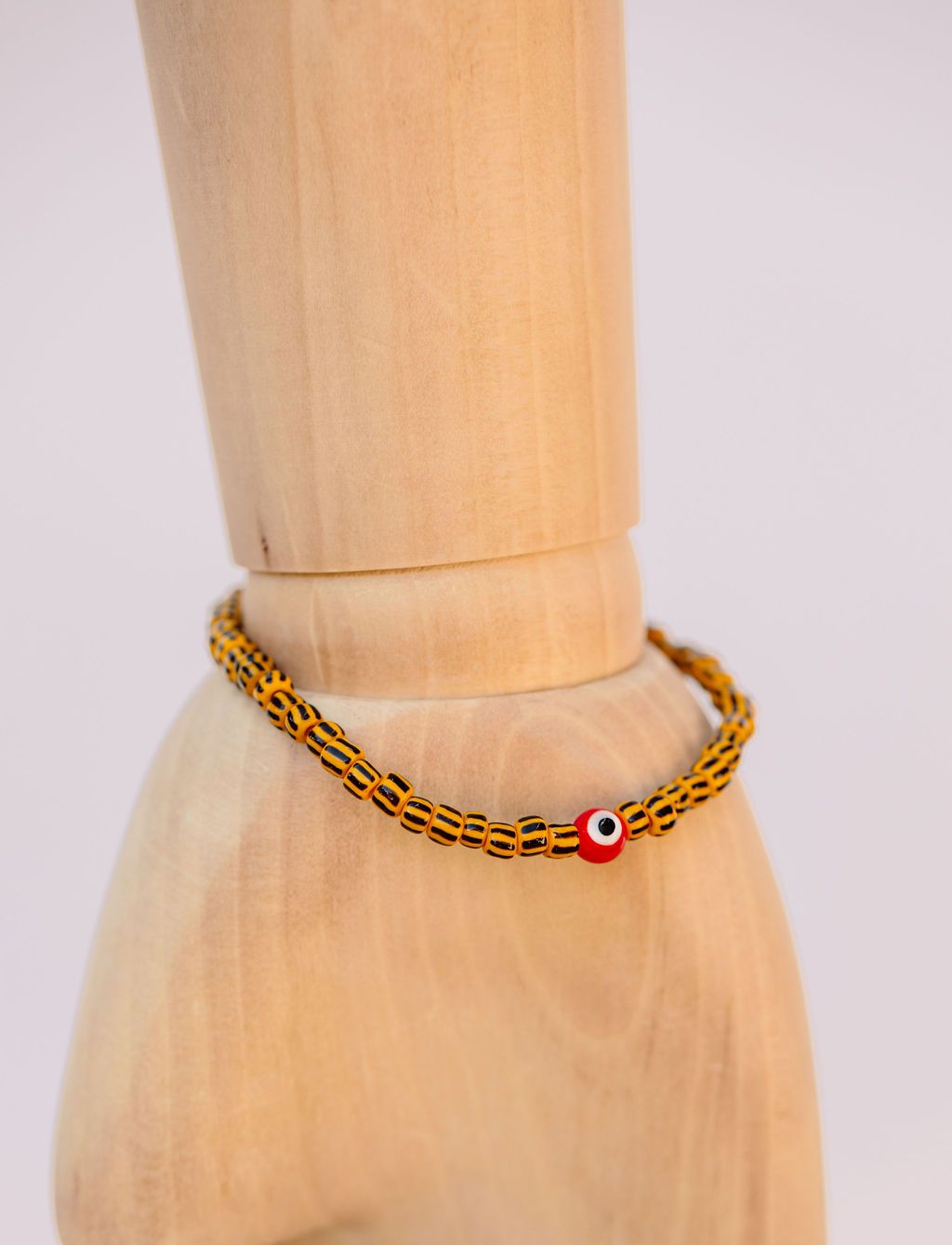 Black & yellow striped Japanese glass beads on sturdy elastic. For that little pop of color and protection for your personal space bubble. Wear just one or stack 'em.