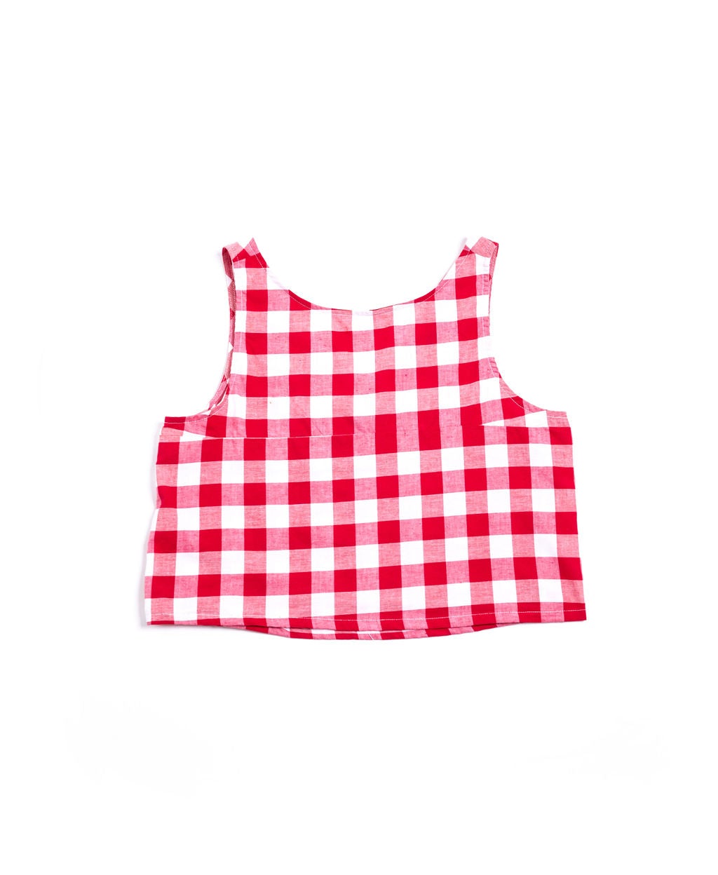 A versatile reversible swing tank in red and white gingham or black and white gingham. Sustainably made in the USA from deadstock cotton. Easy care.