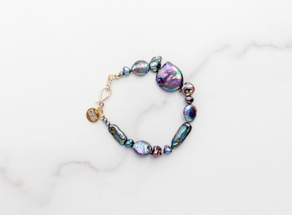 7” strung on soft but strong flexible coated gold wire with beautiful biomorphic shaped iridescent beauties. These pearls will have you daydreaming about your next beach trip and they stay put with our elegant gold fill hook eye clasp. freshwater pearl bracelets, punkwasp by Carrie Marill