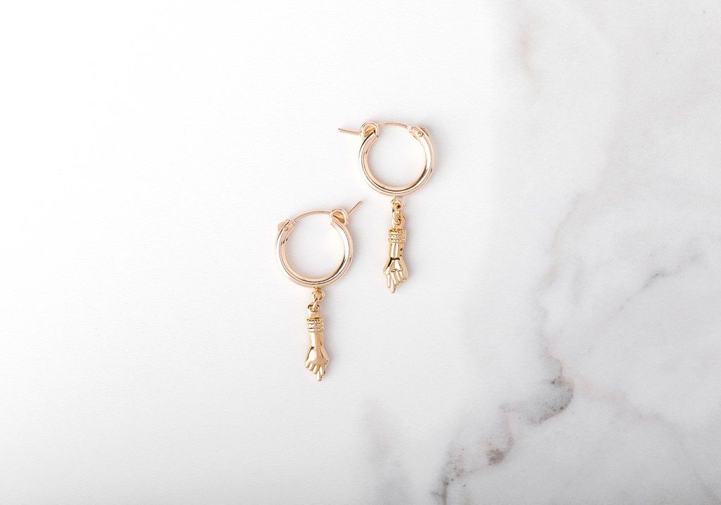 The specific symbolism that gave rise to the “Mano Figa” charm originates in Etruscan Italy. “Mano” means hand and “Figa” means fig, a slang term for female genitalia. What I like to term the “Power of the Puss” symbol ;)  14k gold fill hoops and Mano Figa charm