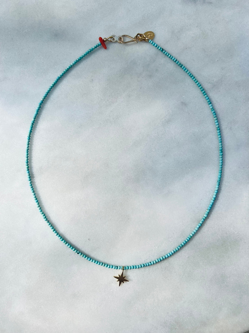 18" Turquoise strung on coated gold wire, accented with star charm and Coral, with Gold Vermeil clasp.  "Work. Play. Reason. Faith. Turquoise delivers on all of the above, empowering us to just let ourselves be human.  Turquoise can help translate the biggest feels into the right words in any language." Available at PUNKWASP