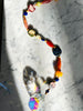 Embellish your space with window prism - hang in a sunny spot & watch the rainbows dance! Inspired by the artsy-fartsy grannies you would find in Seattle. Made with Himalayan fire agate, lace agate, lapis lazuli, iron zebra jasper, honey copal, carnelian, dumortierite, jade, beaded on sturdy wire, faceted prism. designed by Carrie Marill.
