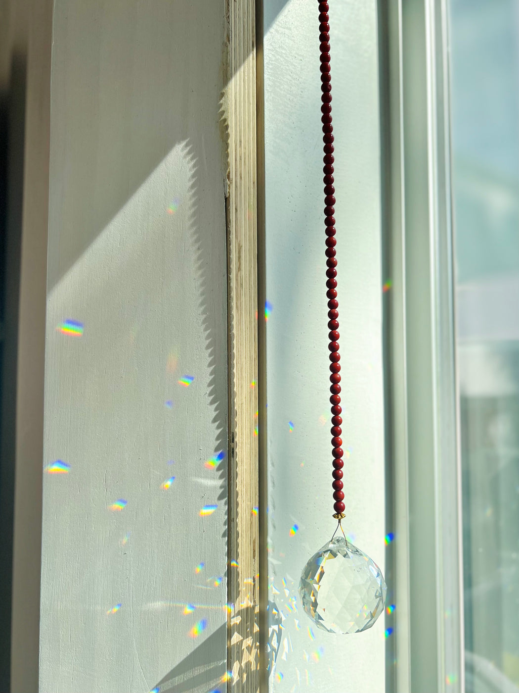 Embellish your space with coral window prism - hang in a sunny spot & watch the rainbows dance!  Coral - an amulet from the sea, provides protection over the feminine & our emotional waters. Said to also nourish blood cells.