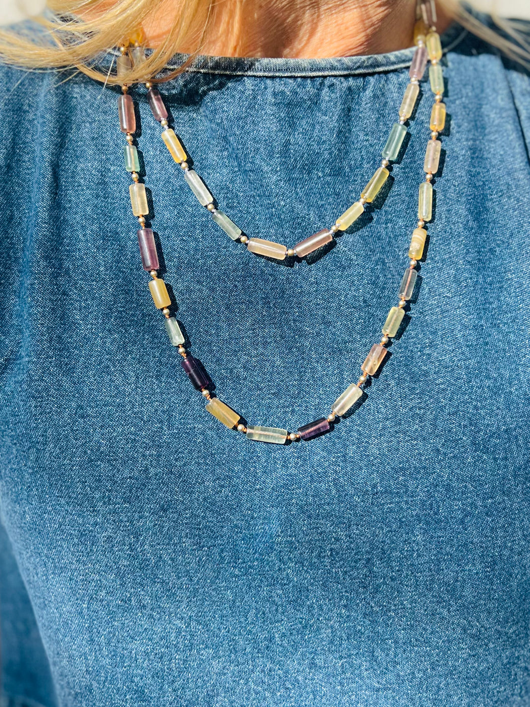 Ground into Mama Earth's natural beauty with organic colors of Tourmaline, hand knotted on silk chord with gold accents for the Empress that you are.  Materials Matter: Varied color tourmaline tube beads, hand knotted on silk cord with gold fill findings and lobster clasp. Necklace Designed in California by Carrie Marill.