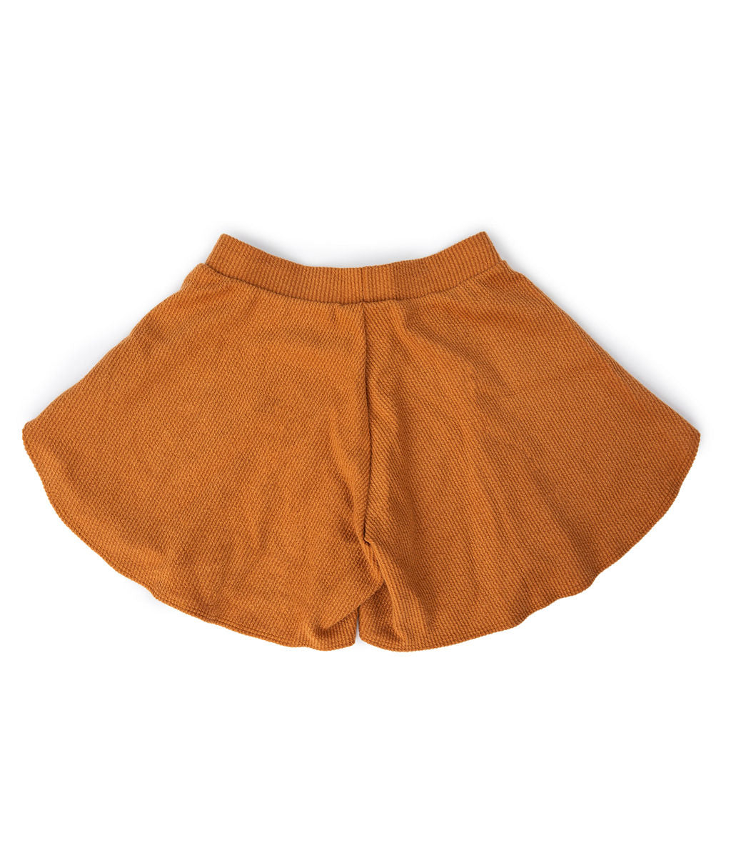 Pull on and flow. These flowy shorts are inspired by hot AF Arizona days when pants are too much to bear. The anti-jeans. With ribbed cotton and an elastic waistband, they’re just the last-minute disguise your bikini bottoms need for your next adventure. Pop on the matching crop top and you’re all set! Created by PUNKWASP