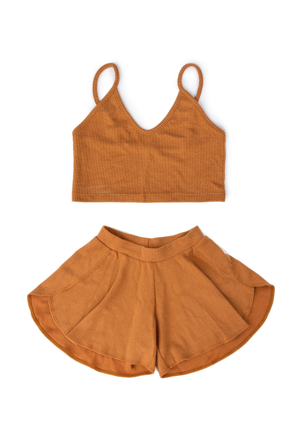 Pull on and flow. These flowy shorts are inspired by hot AF Arizona days when pants are too much to bear. The anti-jeans. With ribbed cotton and an elastic waistband, they’re just the last-minute disguise your bikini bottoms need for your next adventure. Pop on the matching crop top and you’re all set! Created by PUNKWASP