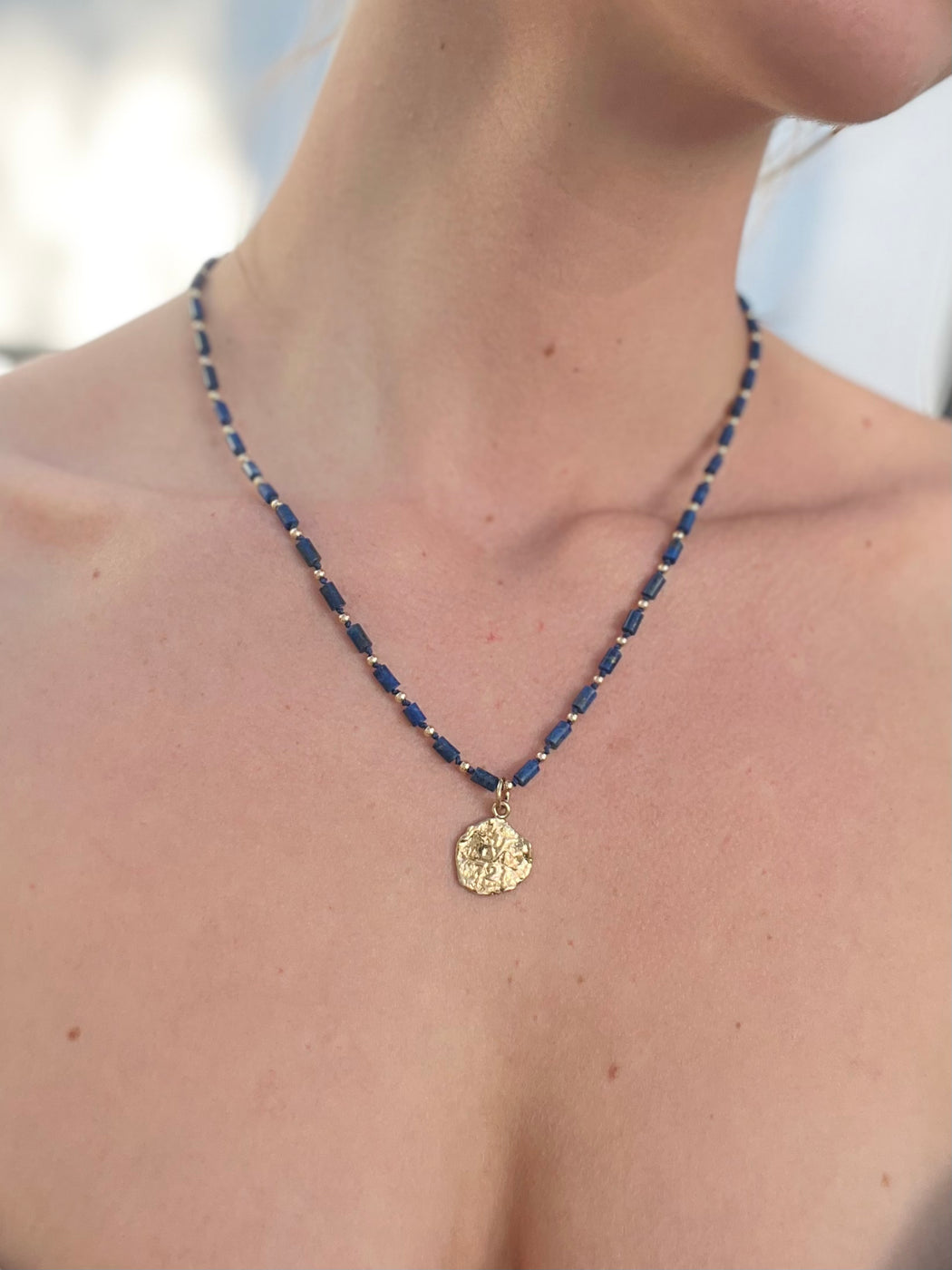 You know the way. Open pathways to your most ancient wisdom with delicate lapis lazuli, beaded along with gold accents. Transcend time through the portal of the Roman gold coin. hand knotted silk chord necklace designed by Carrie Marill 