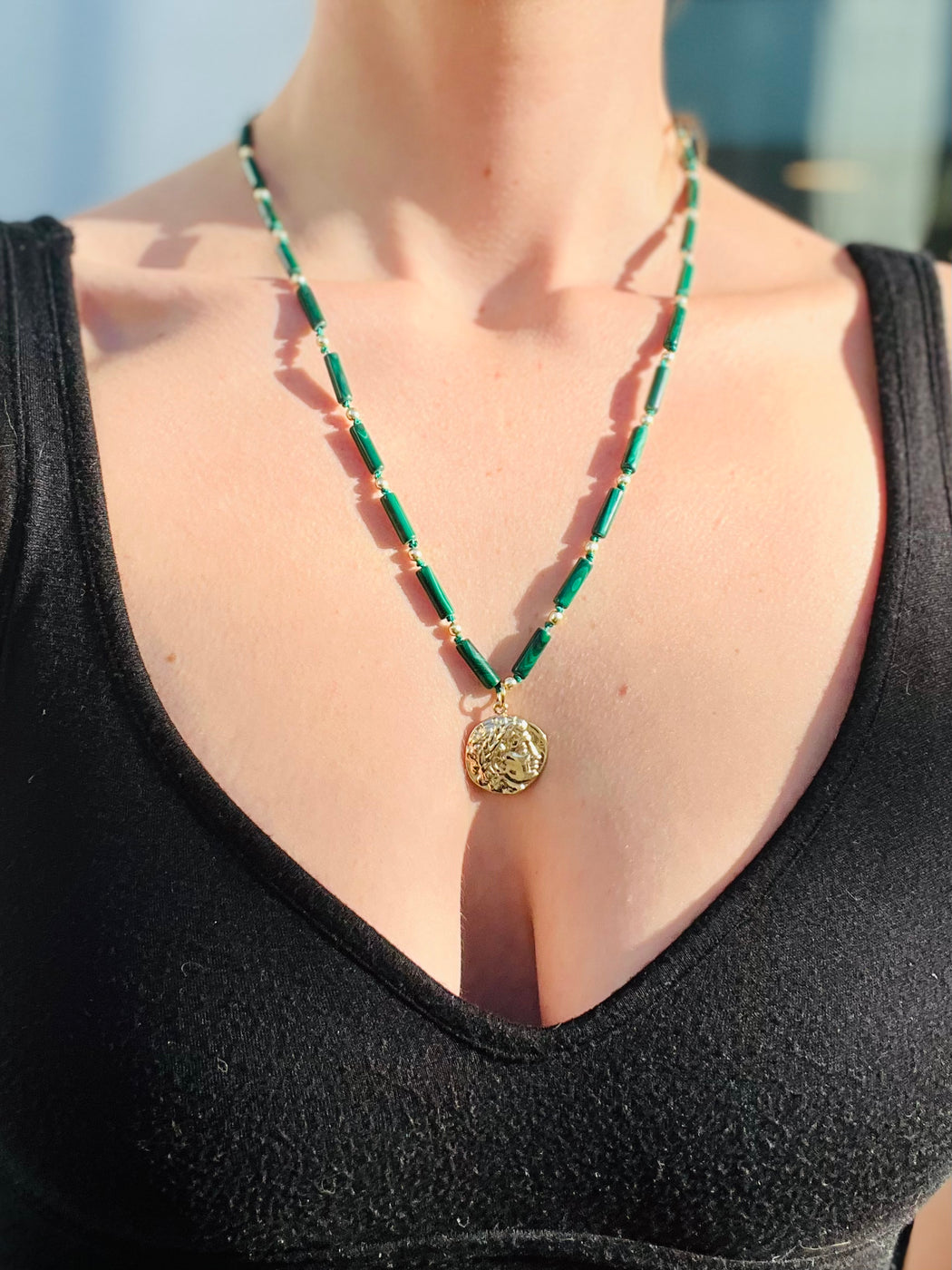 Rise from the ashes. Face your shadows & alchemize the darkness into light with the help of Malachite - the stone of Transformation. Hand knotted on silk chord, Roman gold coin with gold fill beads to light the way ~ 22" necklace designed by Carrie Marill