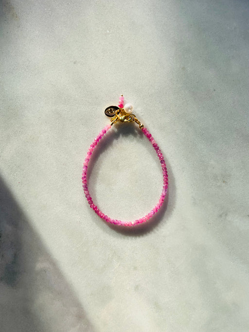  Illuminate the abundance that lives within you - Pink Sapphires remind us of the unlimited love & joy in the universe available to us. Pearl accented for a dash of extra femininity. -- Pink Sapphire's strung on coated gold wire with Gold Fill clasp. Extra sapphires dangle with pearl accent.