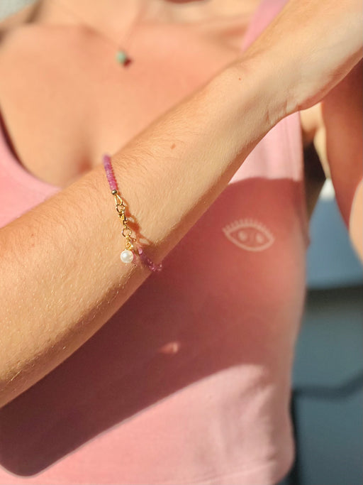  Illuminate the abundance that lives within you - Pink Sapphires remind us of the unlimited love & joy in the universe available to us. Pearl accented for a dash of extra femininity. -- Pink Sapphire's strung on coated gold wire with Gold Fill clasp. Extra sapphires dangle with pearl accent.
