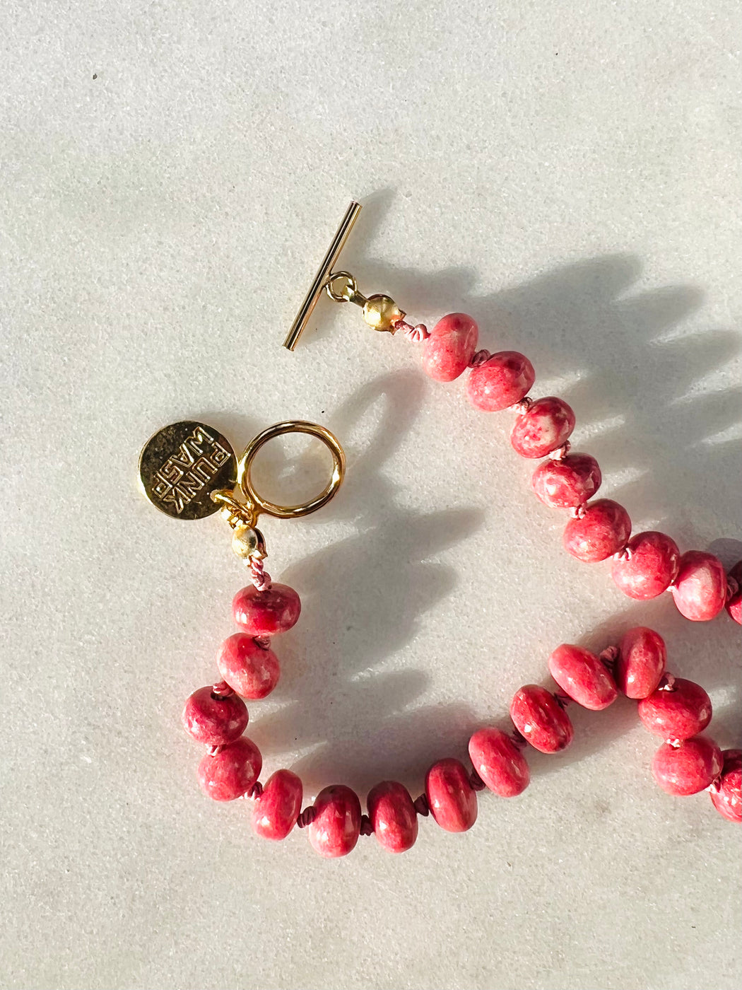 Thulite on hand knotted silk chord, with freshwater pearl & Turquoise, gold fill clasp. 19"