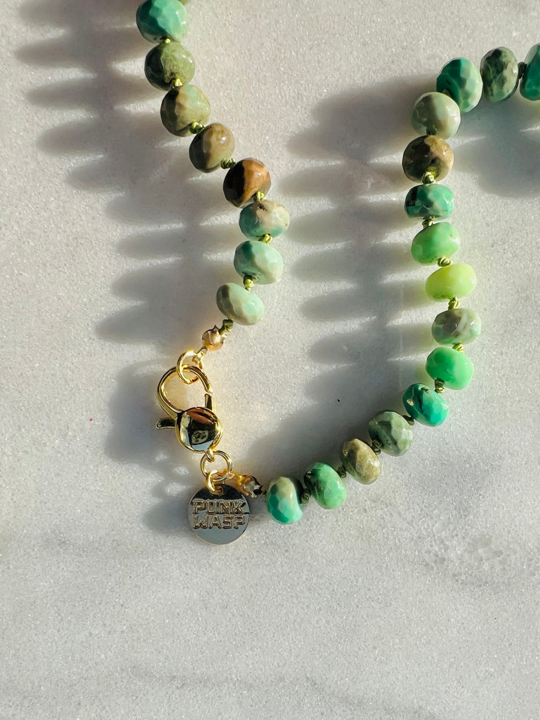 Faceted Ombre Chrysoprase on hand knotted silk chord, with glass eye charm, gold fill clasp.  Named after the green one eyed figure we all know as Mike Wazowski - a perfect reflection of the Chrysoprase hues & eye charm pairing.